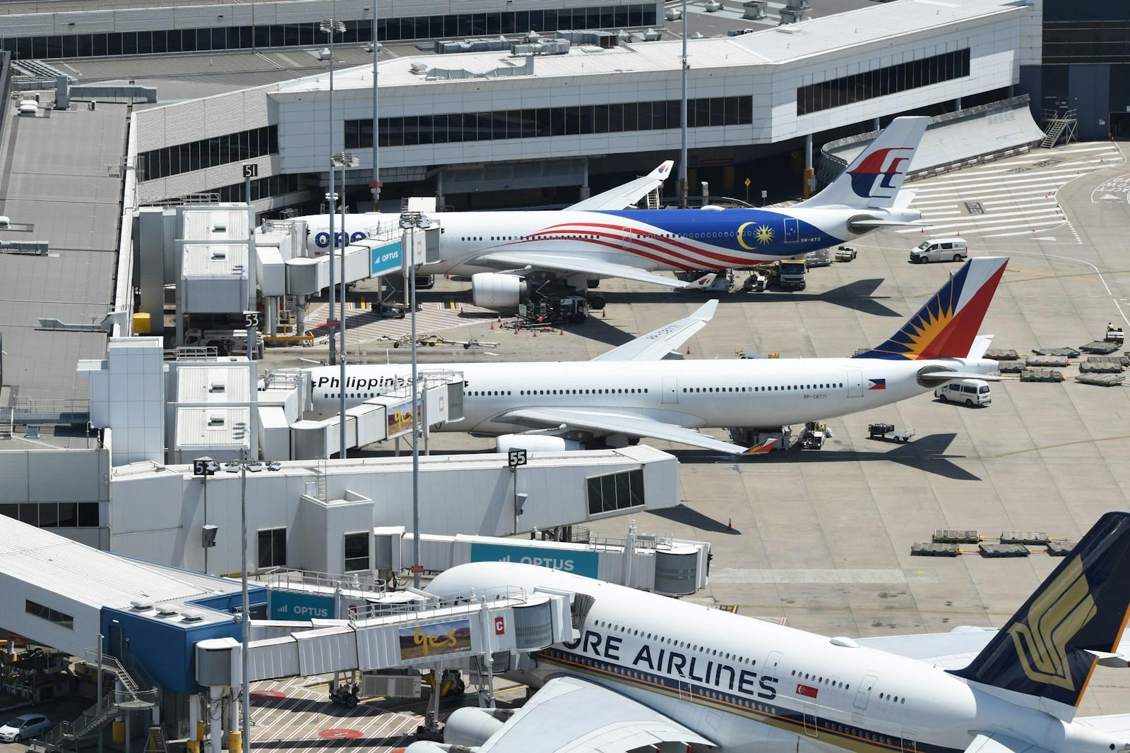 International aircraft parked at jet bridges at Sydney Airport Terminal 1, Mascot